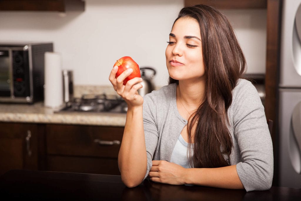 Mindful Eating - Woman eating an apple